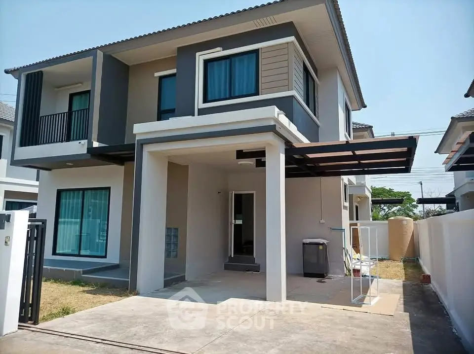 Modern two-story house with carport and stylish facade in a suburban neighborhood.