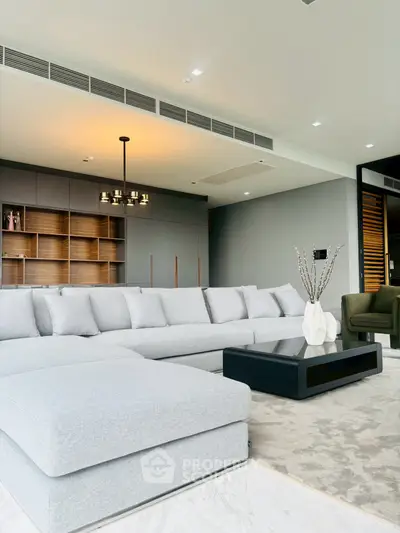 Spacious modern living room with elegant gray sofa and stylish decor