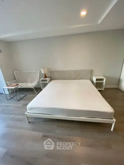 Spacious modern bedroom with minimalist design and cozy ambiance