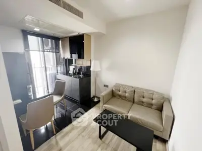 Modern compact living room with kitchenette and stylish furniture