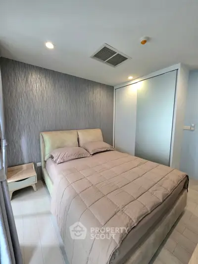 Modern bedroom with stylish decor and cozy bed in a contemporary apartment.