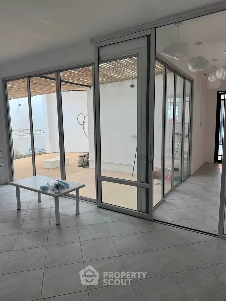 Spacious modern living area with large sliding glass doors leading to a private patio.