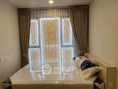 Cozy bedroom with large window and elegant curtains