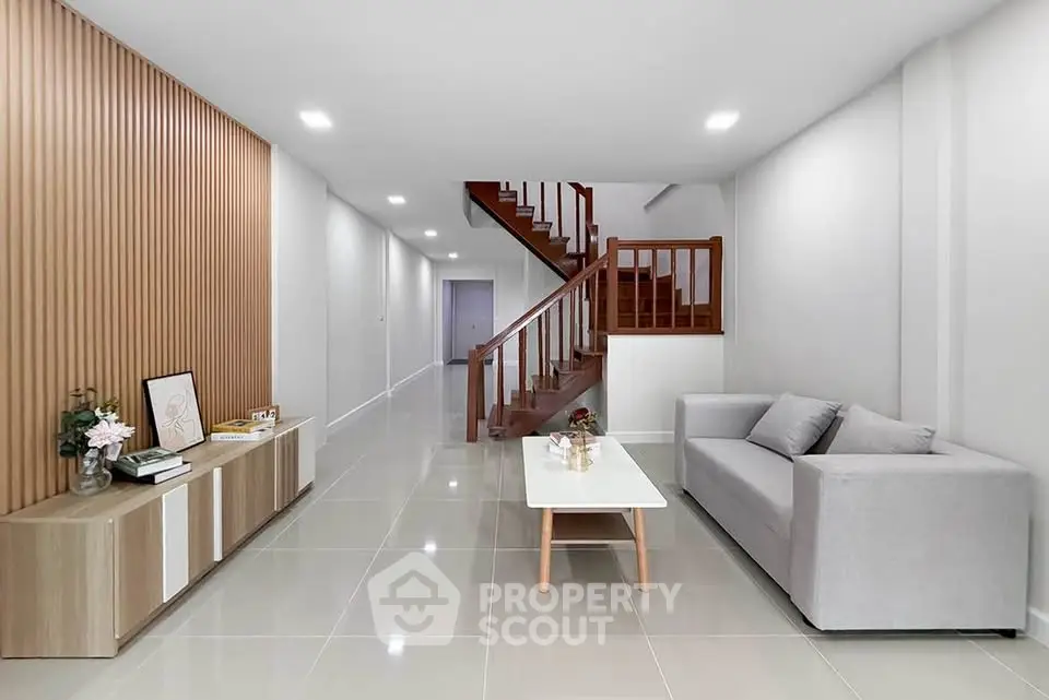 Modern living room with sleek design and elegant staircase