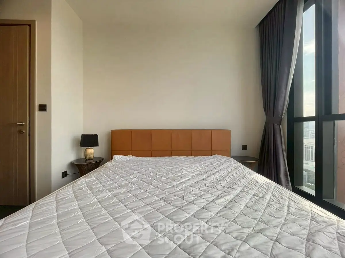 Modern bedroom with large window and stylish decor