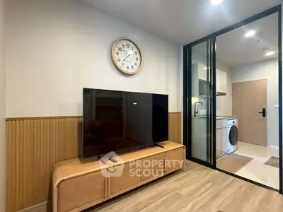 Modern living room with TV and washing machine in sleek apartment