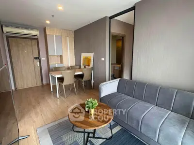 Modern living room with stylish furniture and wooden flooring in a cozy apartment.