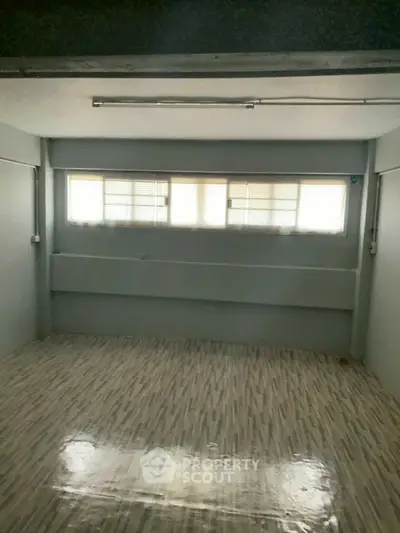 Spacious empty room with large windows and tiled flooring, ideal for customization.