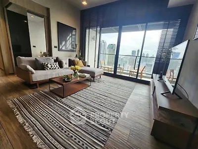 Spacious living room with modern decor and stunning city view balcony.