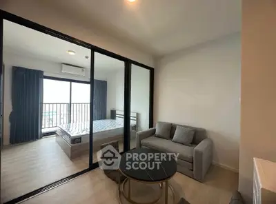 Modern apartment with glass partitioned bedroom and cozy living area