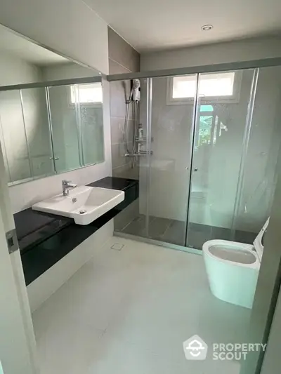 Modern bathroom with glass shower and sleek fixtures