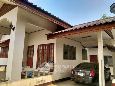 Charming single-story home with carport and traditional architectural details.