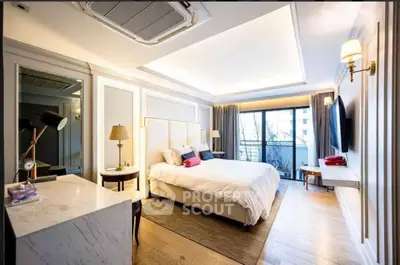 Luxurious bedroom with modern decor and large window offering natural light and a serene view.