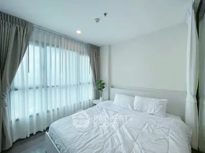 Bright and airy bedroom with large windows and modern decor in a stylish apartment.