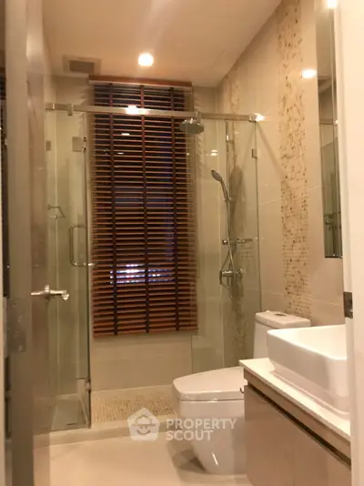 Modern bathroom with glass shower and stylish wooden blinds