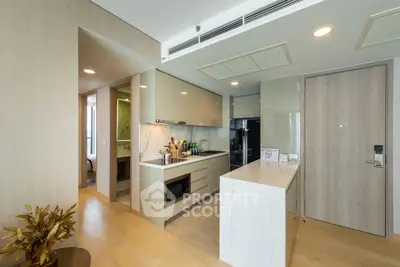 Modern kitchen with sleek cabinetry and marble countertop in a stylish apartment.