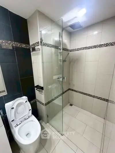Modern bathroom with glass shower and sleek tile design