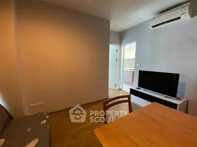 Cozy living room with modern furniture and air conditioning, perfect for relaxation.