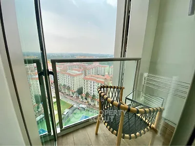 Stunning balcony view overlooking cityscape with cozy seating area, perfect for relaxation.