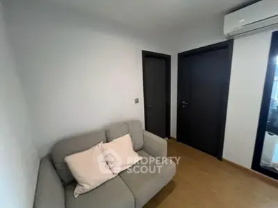 Cozy small living room with modern sofa and air conditioning