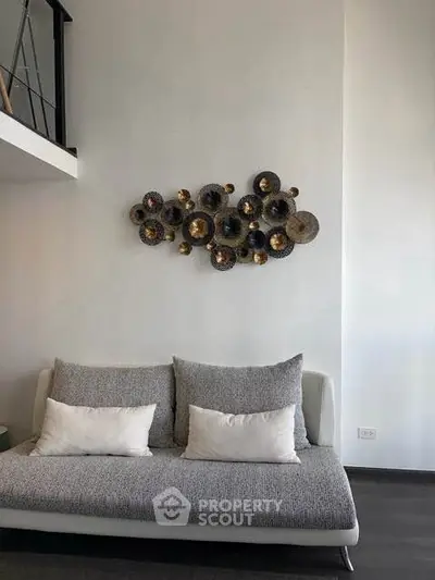 Modern living room with stylish wall art and cozy sofa in a contemporary apartment.