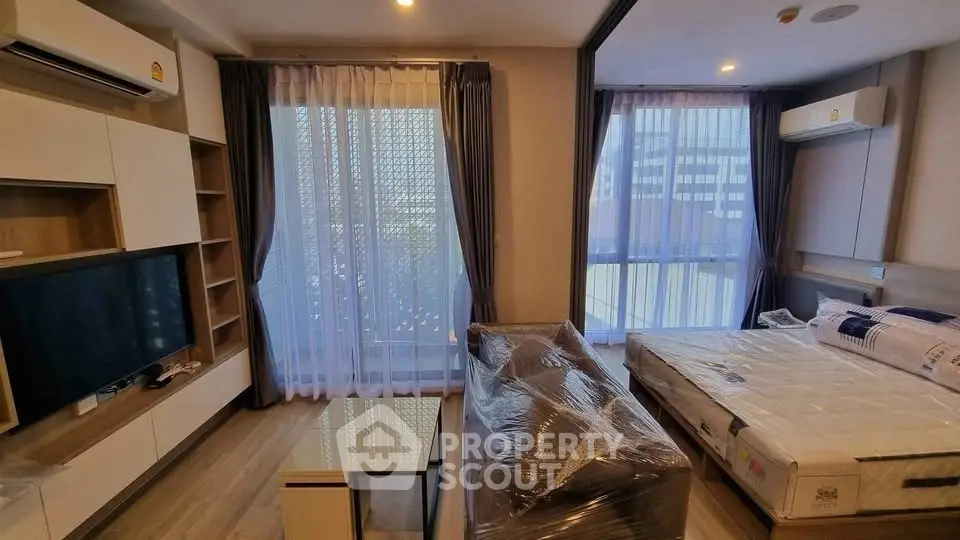 Modern furnished living room with large windows and natural light