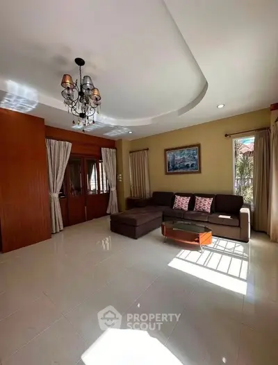 Spacious living room with elegant chandelier and natural light