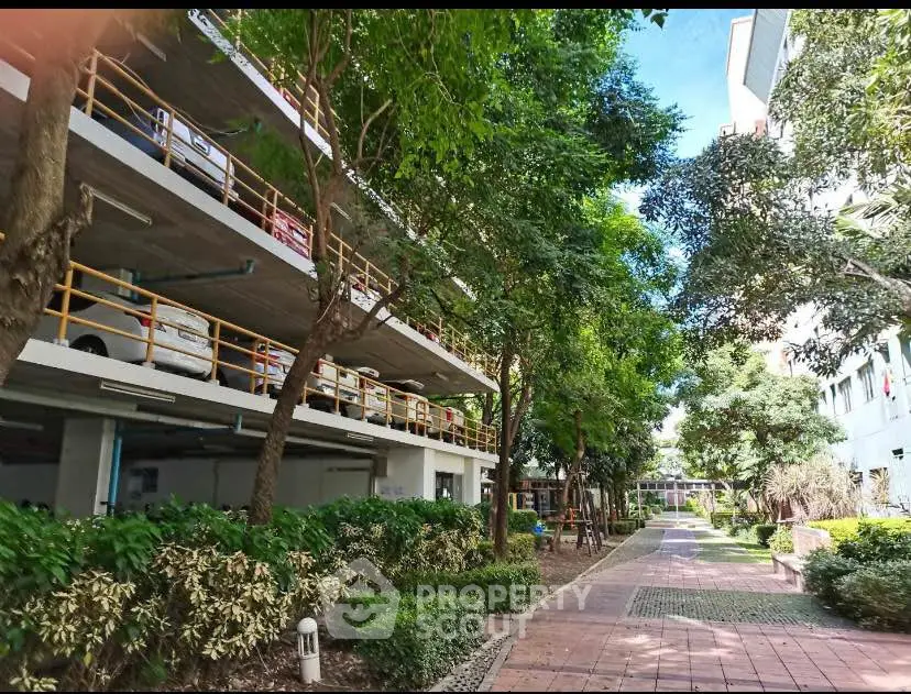 Charming residential parking area with lush greenery and pathway