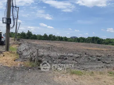 Expansive vacant land with potential for development under clear blue skies.