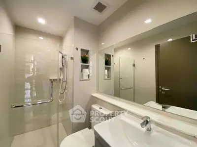 Modern bathroom with sleek fixtures and spacious shower area