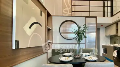 Modern dining area with stylish decor and open kitchen layout in a contemporary apartment.