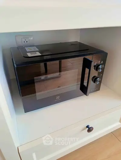 Modern microwave oven in sleek kitchen cabinet setup
