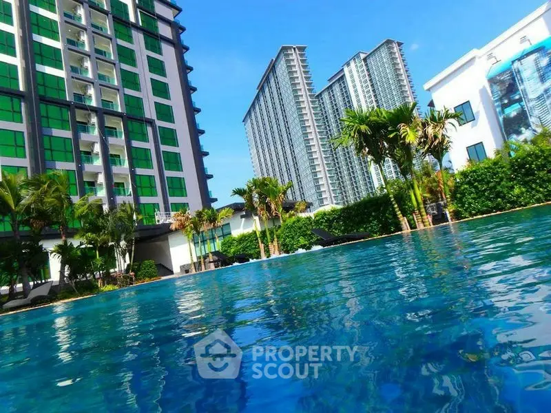 Luxurious high-rise apartments with stunning pool and lush greenery, perfect for modern living.