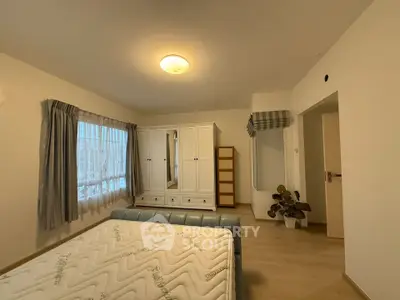 Spacious bedroom with modern furniture and natural light