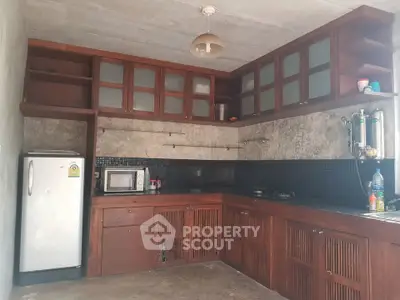 Spacious kitchen with wooden cabinets and modern appliances