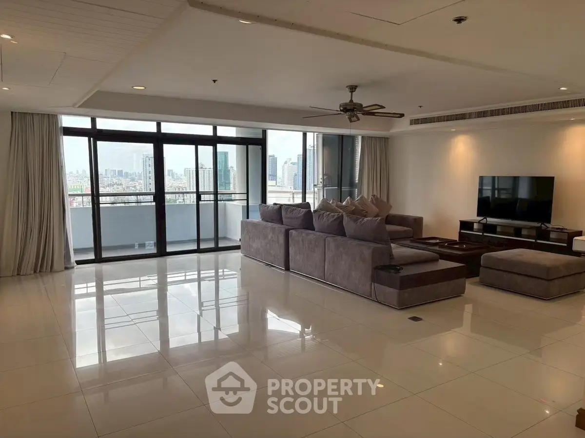 Spacious modern living room with large windows and city view, featuring elegant furniture and sleek design.