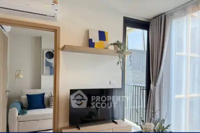 Modern living room with balcony access and stylish decor in a bright apartment.