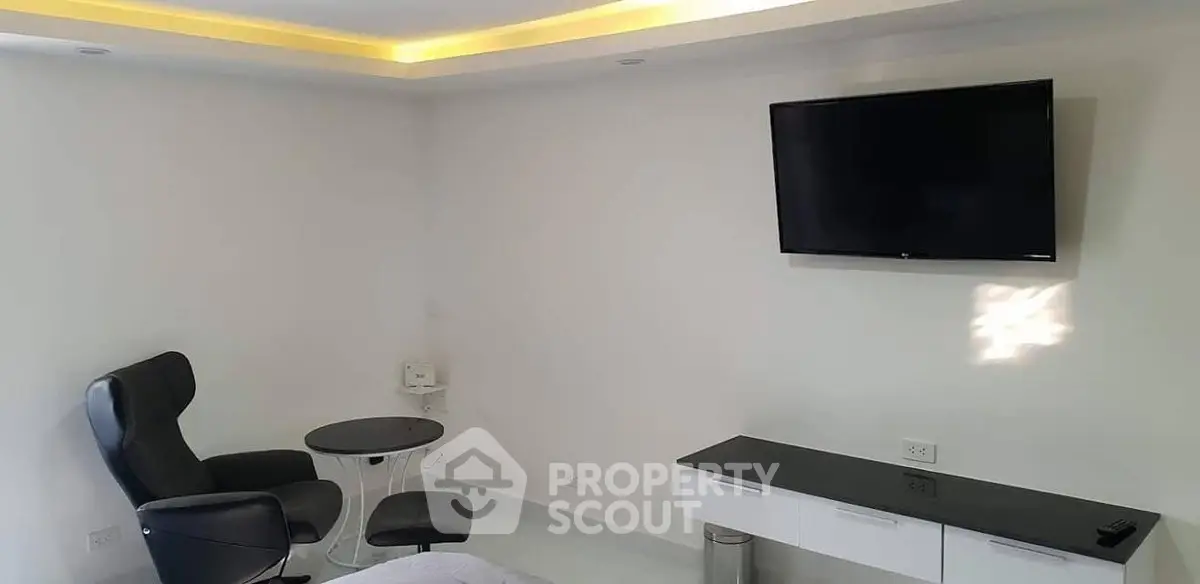 Modern minimalist living room with sleek furniture and wall-mounted TV