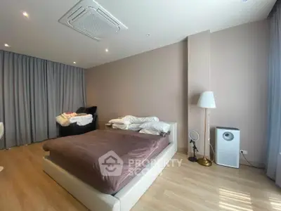 Spacious modern bedroom with elegant decor and natural light