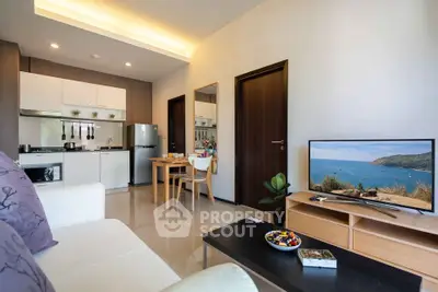 Modern living room with open kitchen and scenic view on TV