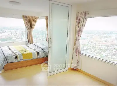 Bright bedroom with panoramic city view and modern decor
