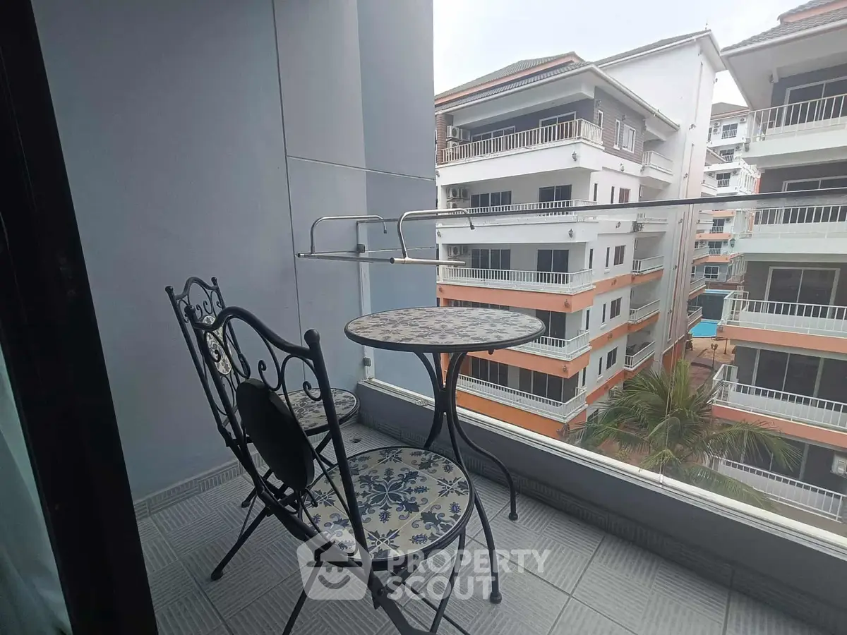 Charming balcony with stylish furniture and city view, perfect for relaxing and enjoying the outdoors.