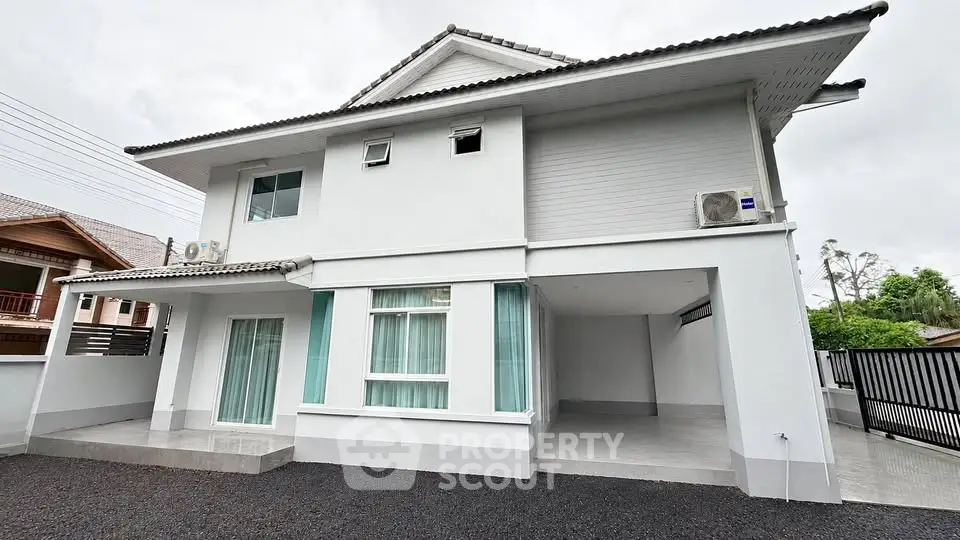 Modern two-story house with sleek design and spacious driveway, perfect for family living.