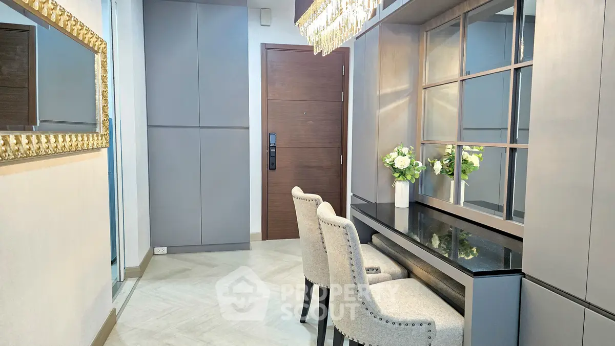 Elegant entryway with modern decor and chic seating area, perfect for welcoming guests.