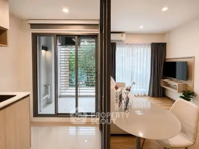 Modern open-plan living room with dining area and balcony access