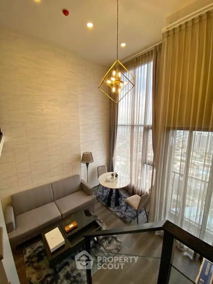 Luxurious high-ceiling living room with modern decor and stunning city view.