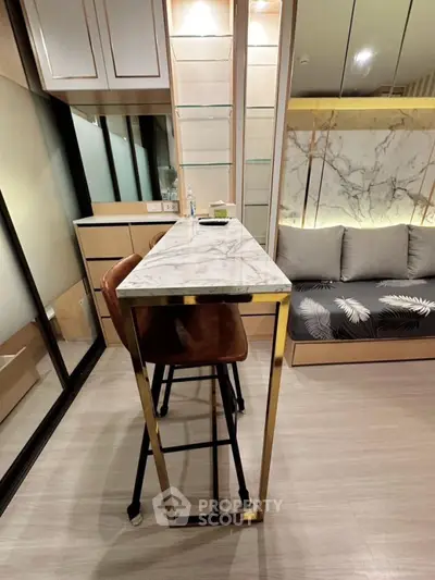 Modern interior with sleek marble table and cozy seating area in stylish apartment.