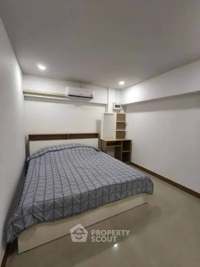 Cozy bedroom with modern design and ample storage space, perfect for urban living.