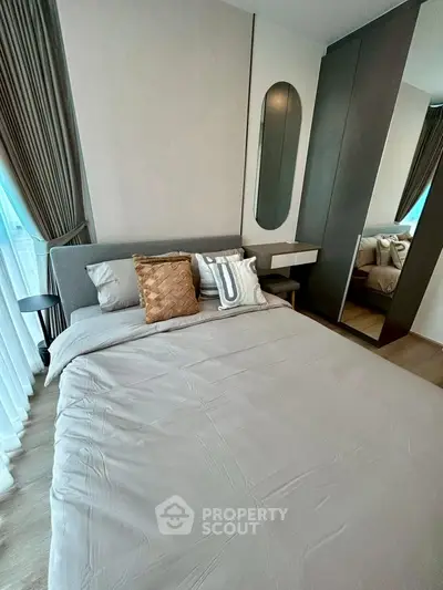 Modern bedroom with stylish decor and large mirror wardrobe
