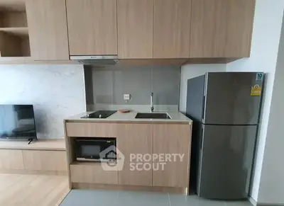 Modern kitchen with sleek cabinets, built-in appliances, and spacious fridge.